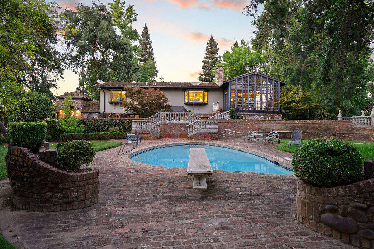 The swimming pool looks back toward the Schuering family’s home along the Sacramento River. The grounds are arranged as a series of intimate outdoor spaces, including winding paths, gardens, a gazebo and a fountain.
